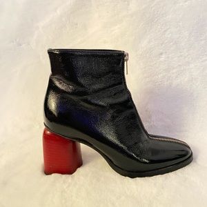 Beautiful Italian patent leather boots in black with a red heel and full zipper.